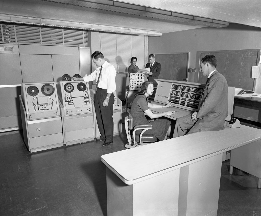 people standing around a large computer at Georgia Tech in 1959