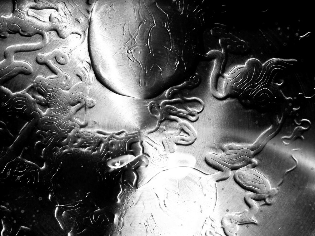 an abstract black and white monochrome image made from oil as it heats in water