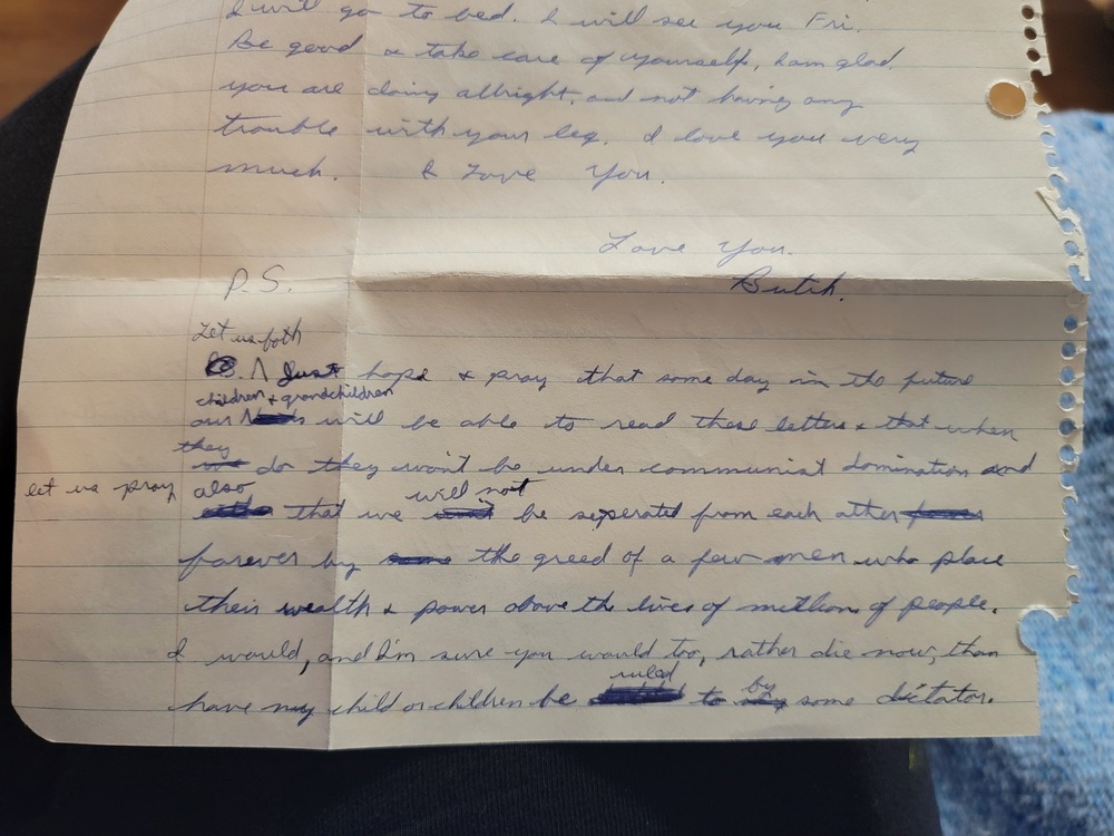 the postscript of a hand written letter written by a young man (photographer Earl J. Warren) when he was 18, revealing fears of communist dictatorship in the year 1962. 